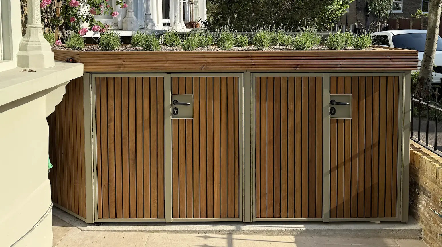 A beautiful bike and bin shed in a London front garden, wrapped around this gorgeous bay window.