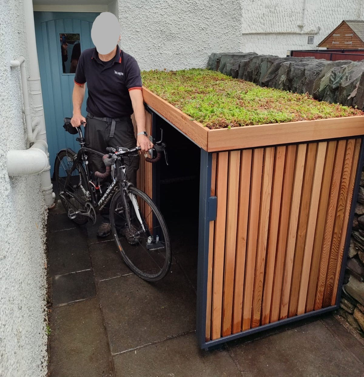 Bespoke green roof bike store with secure sliding door, designed for high-value bikes and tailored to premium residential settings.