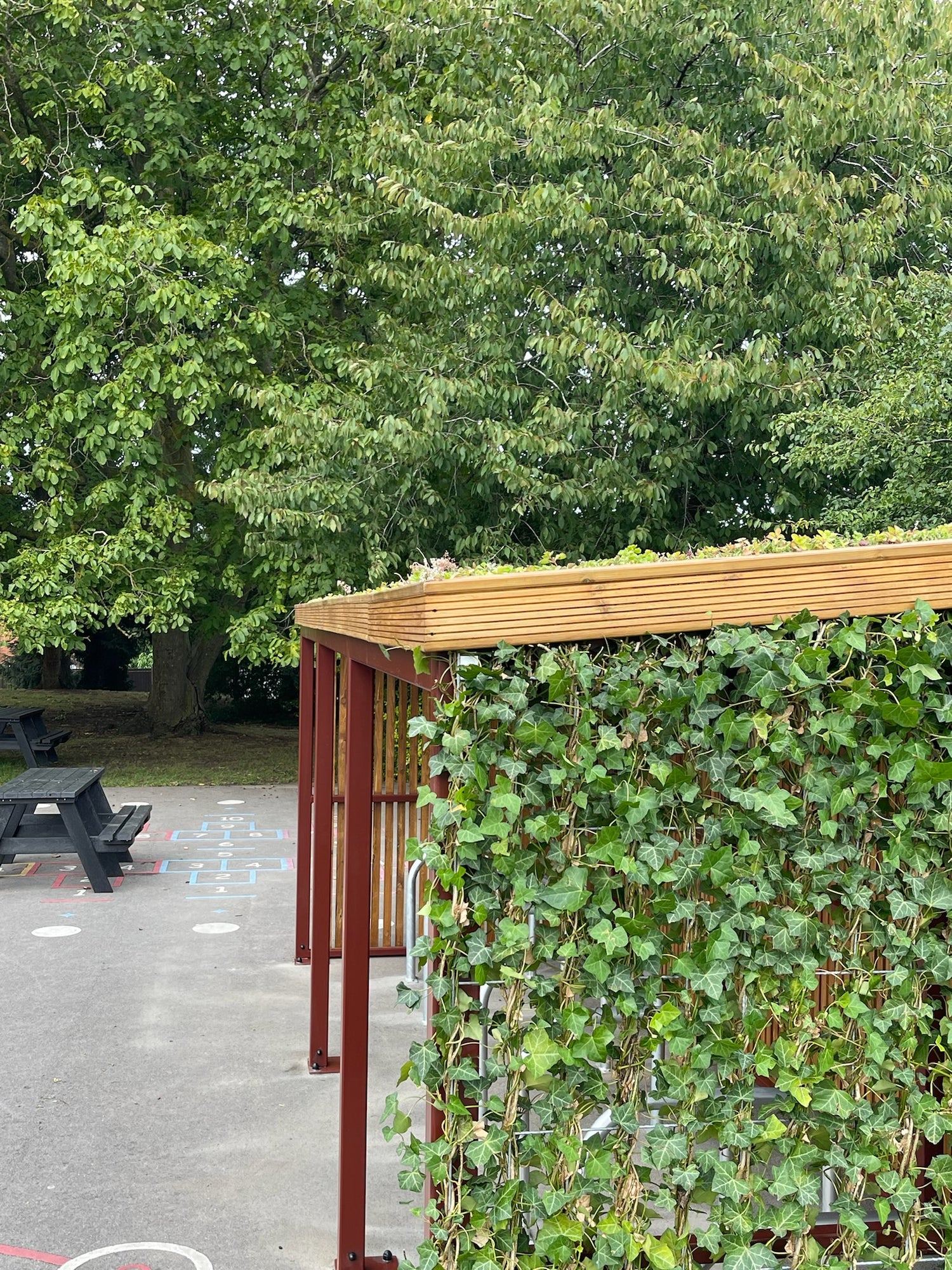 Eco-friendly bike shelter serving as a symbol of commitment to environmental education and social transformation for environmental organizations.