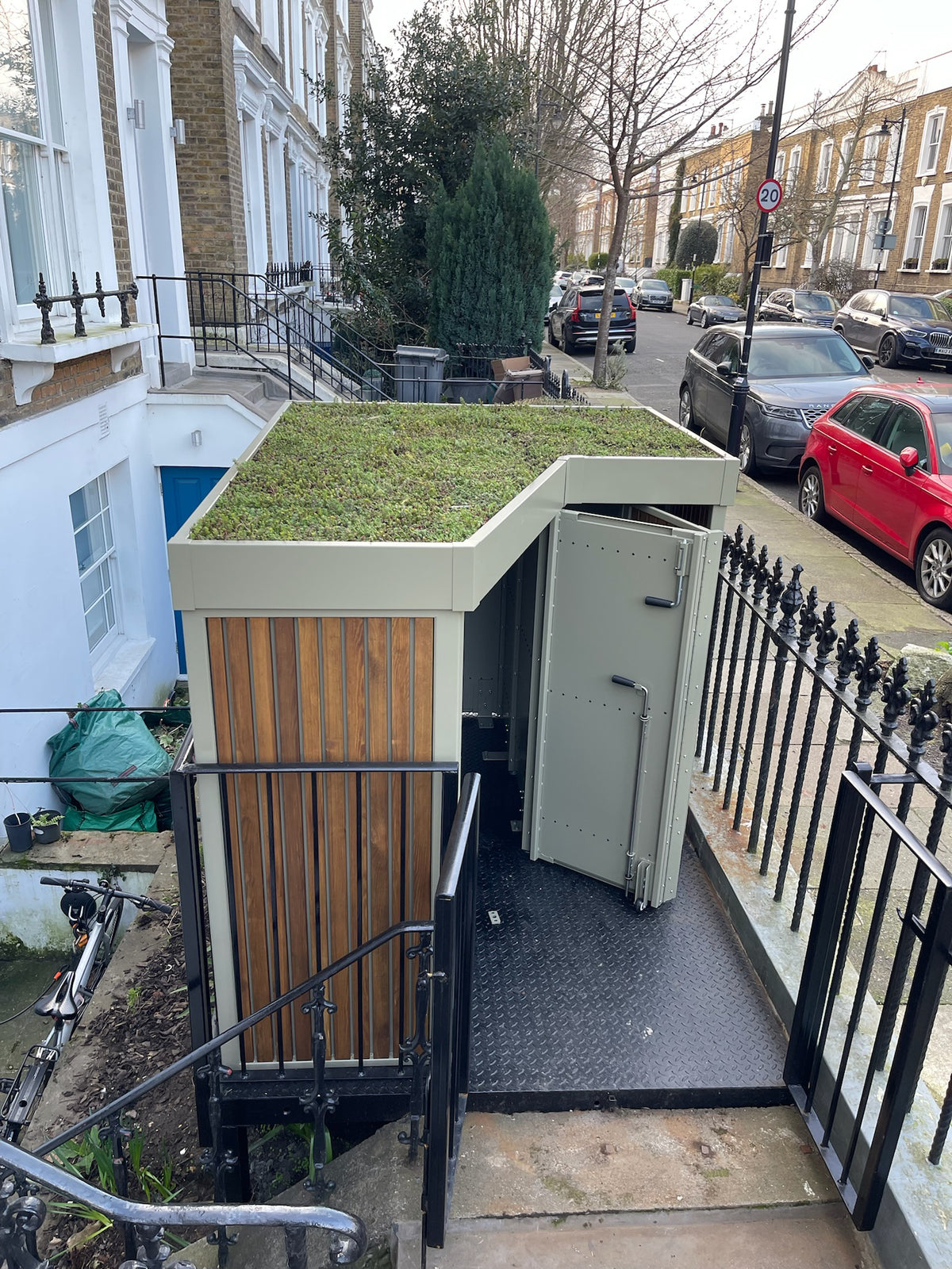 Bespoke cargo bike storage unit featuring a green roof and timber cladding, designed for a Georgian terrace in London.