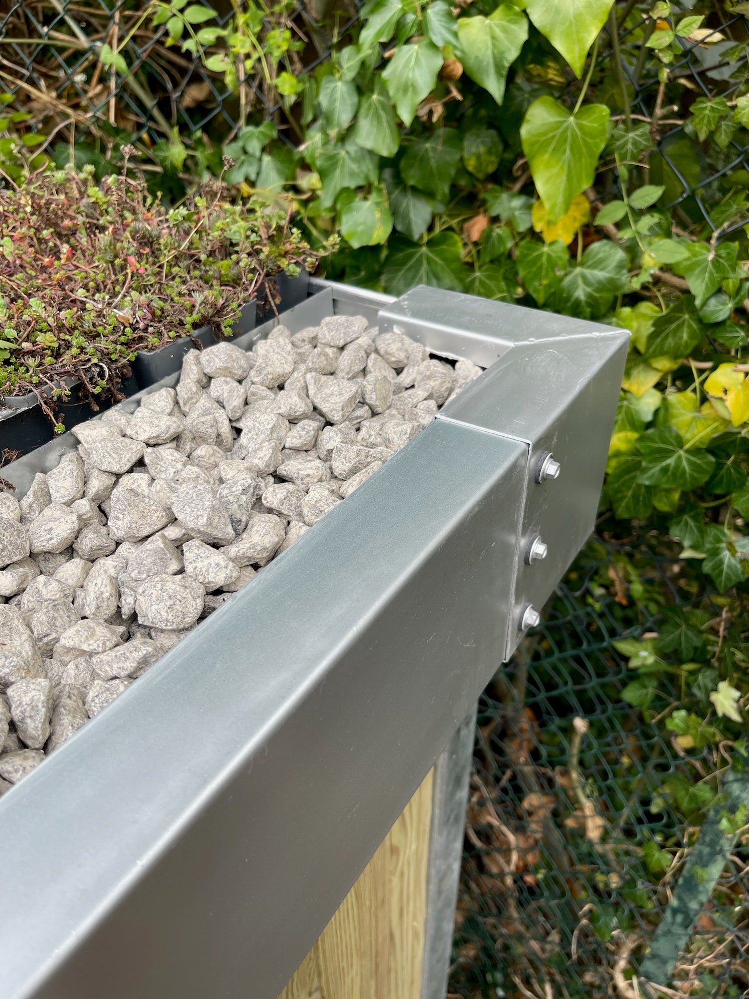 Close-up of durable materials used in constructing a green roof bike shelter, emphasizing longevity and resilience.