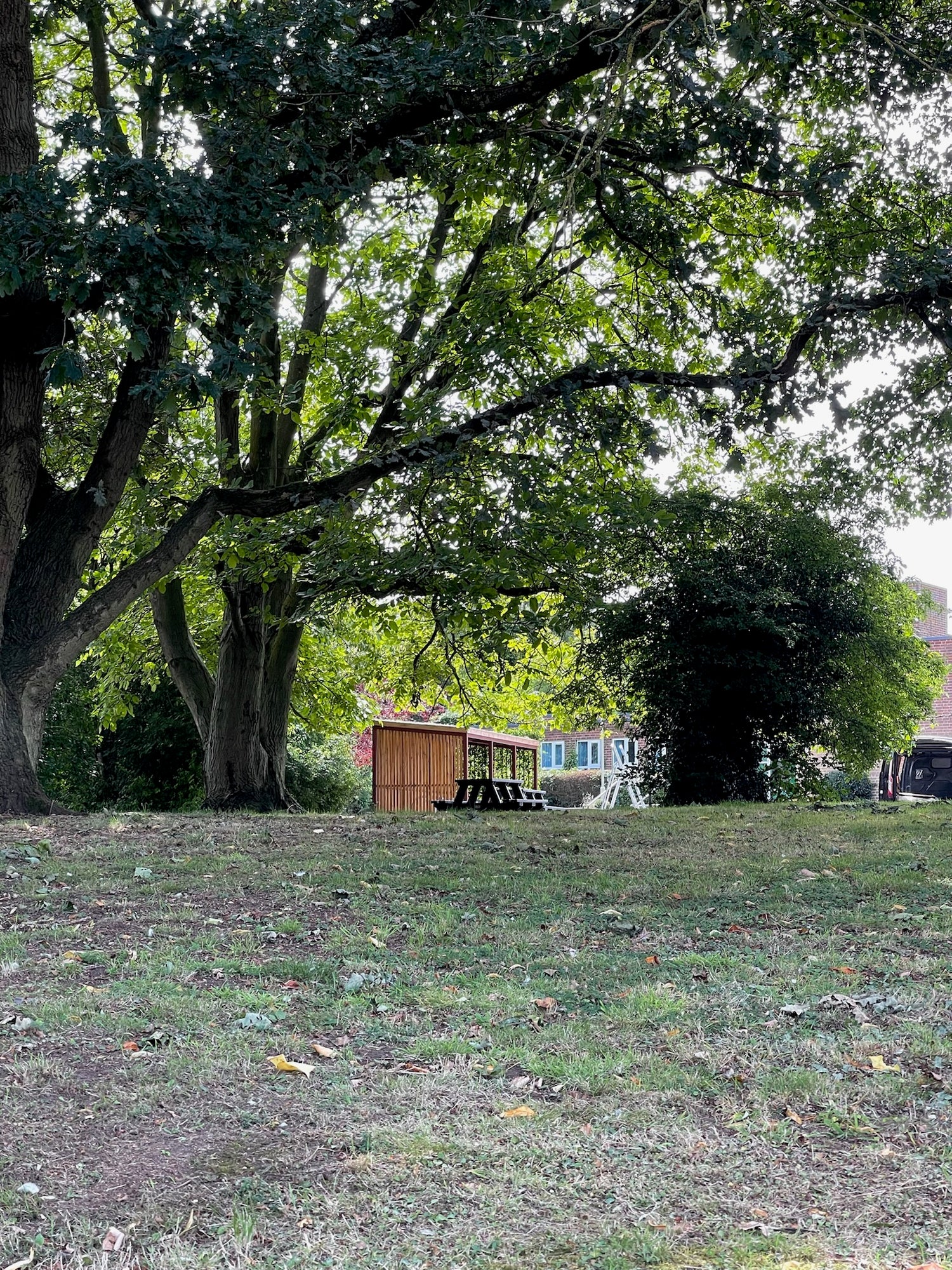Green roof bike shelter promoting sustainability and strengthening community connections within an environmental trust setting.