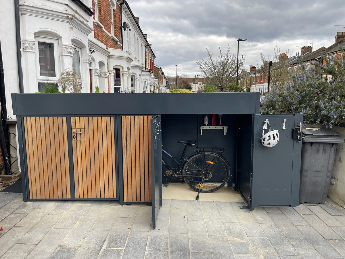 Front view with one side open of a bike storage unit equipped with removable shelving and hooks, organized for triathlon gear and cycling accessories.