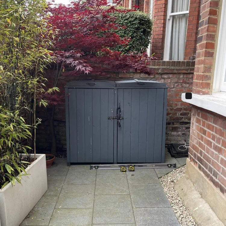 Standard off-the-shelf bike shed placed in a front garden, sitting awkwardly and out of place.