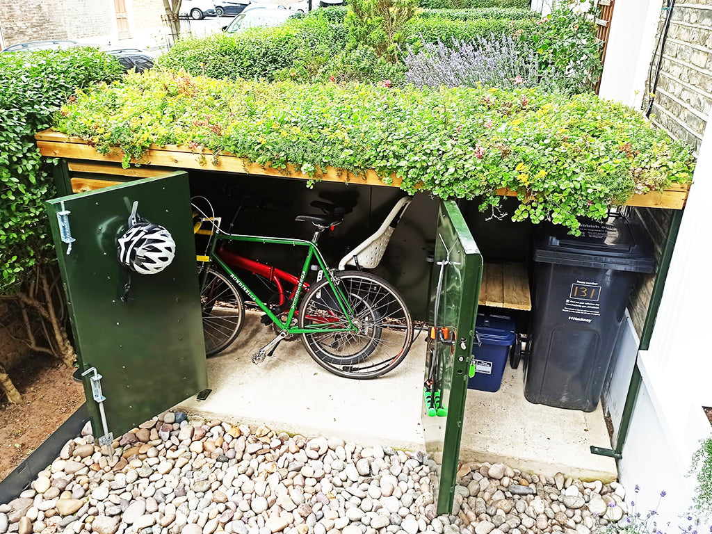 Atlanticbike support team providing assistance with bespoke green roof bike shed installation for homeowners.