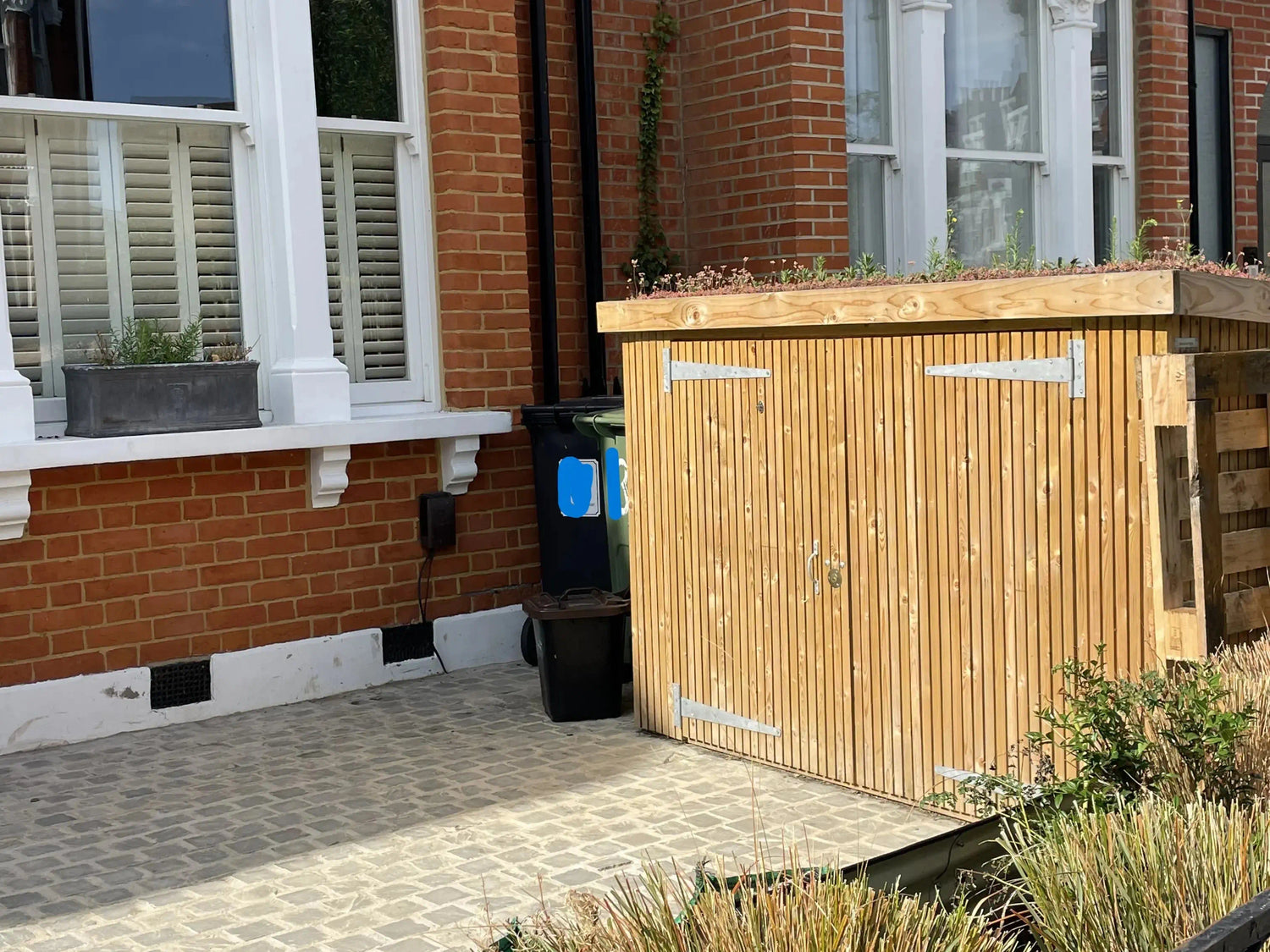 Front garden timber bike shed with sedum green roof