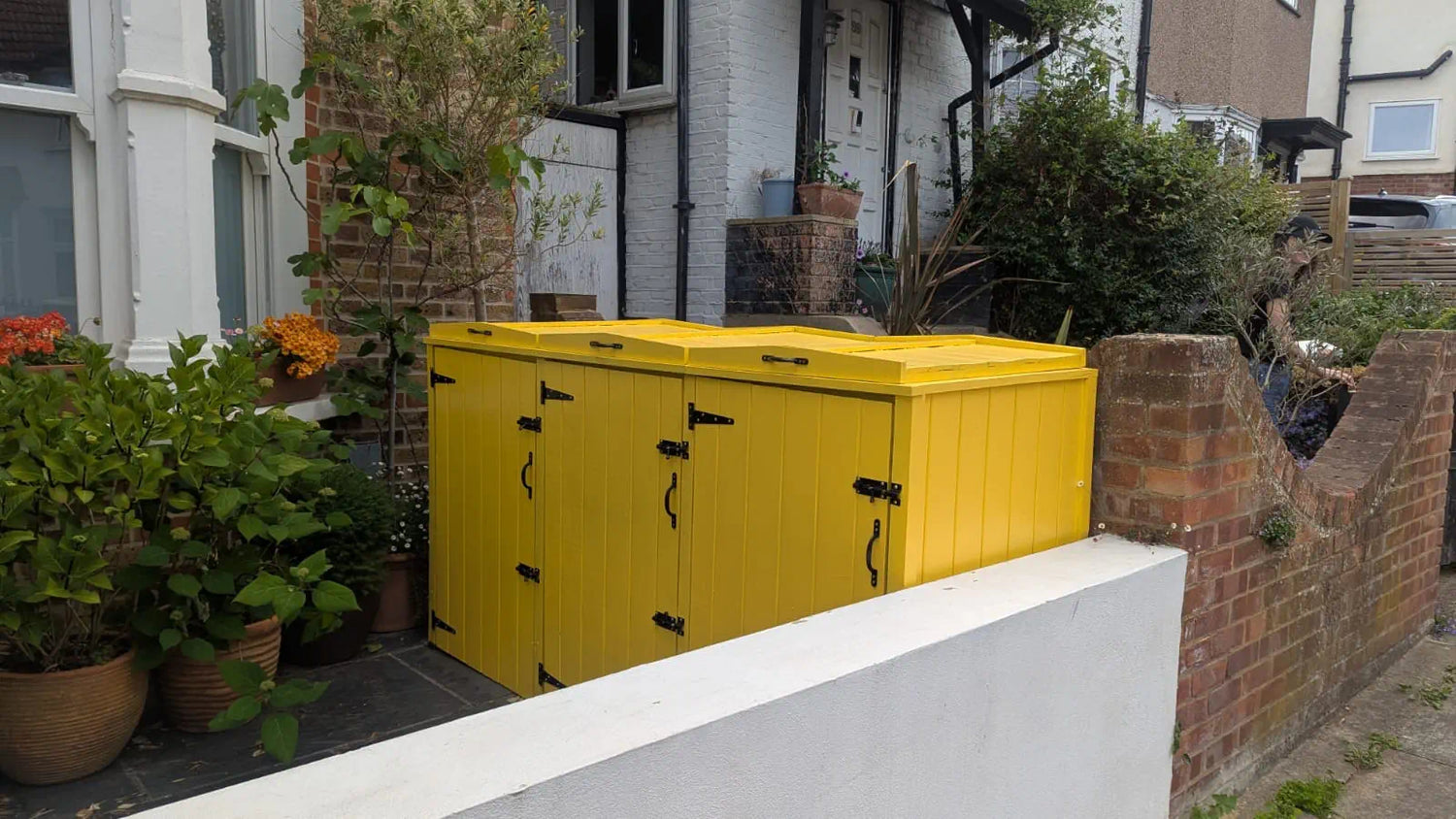Painted triple bin shed in your front garden requires planning permission.