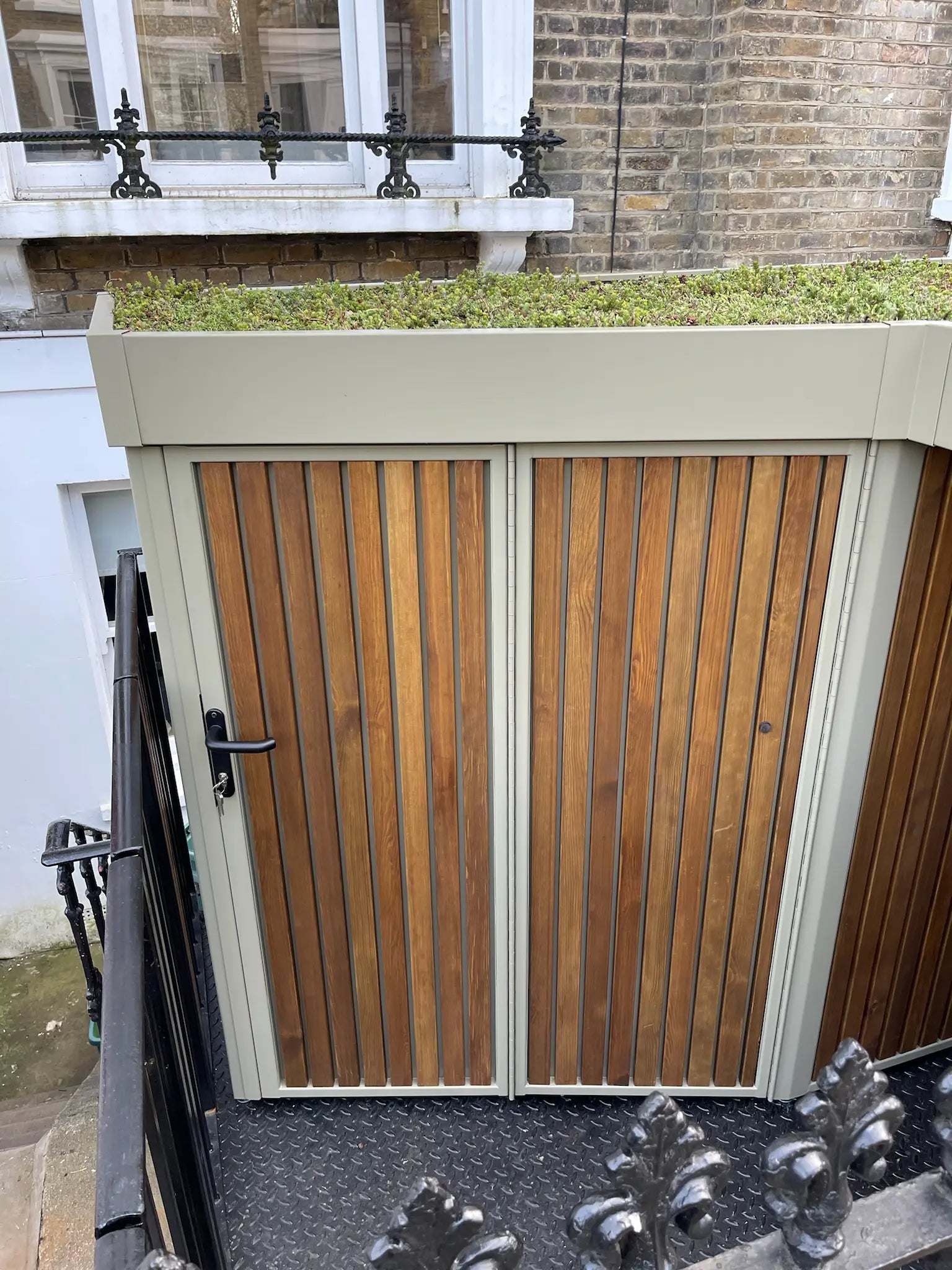 Front view of the Verde cargo bike shed with its double-hinged doors closed for security