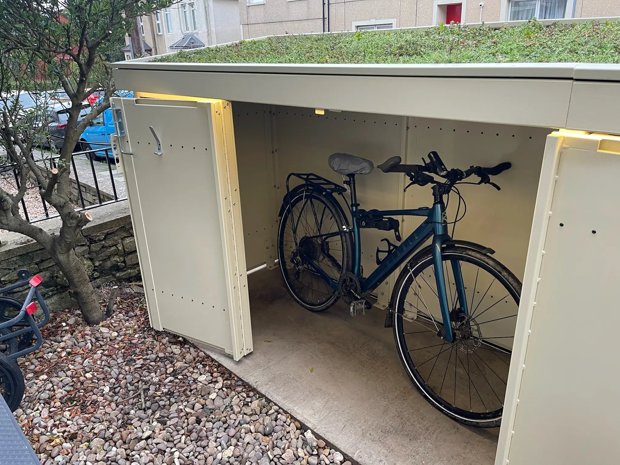 Detail of Verde Plus with door open, revealing a bike stored securely inside