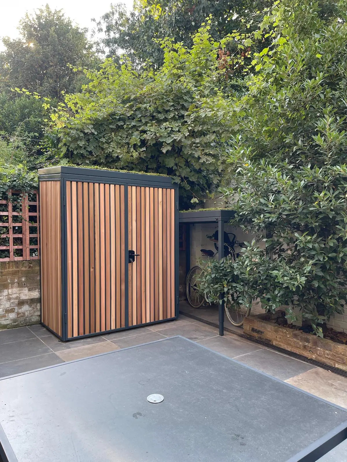 Green Roof bespoke garden shed with cycle shelter for bicycle with child seat