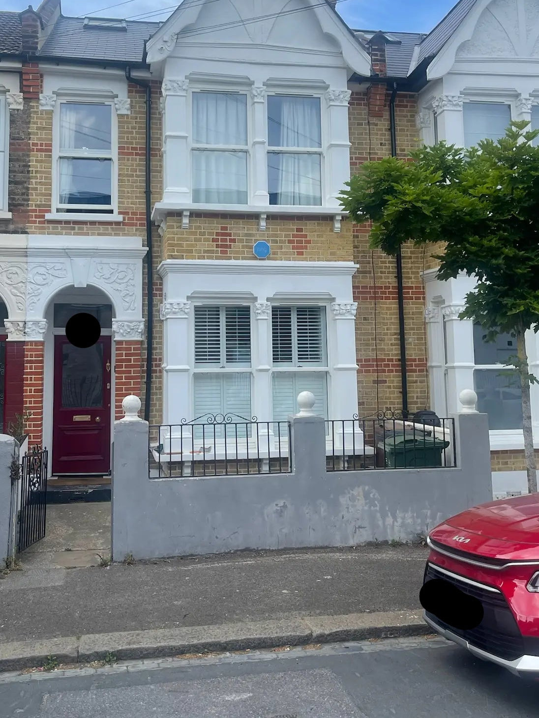 Before image of London front garden with damaged grey boundary wall and neglected, dry appearance prior to bike and bin store installation