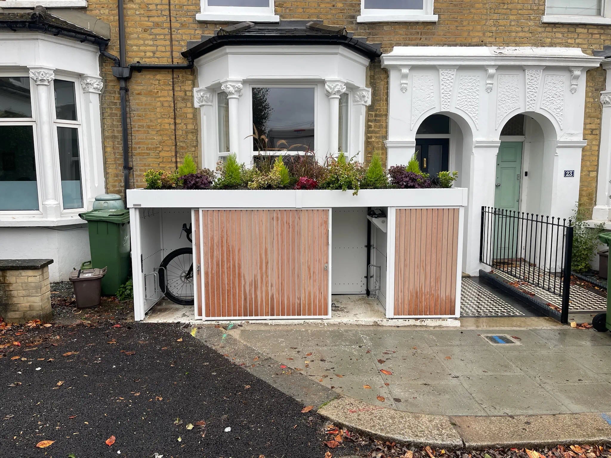 Bike store partially opened, showing smooth sliding doors and accessible cycle storage solution.