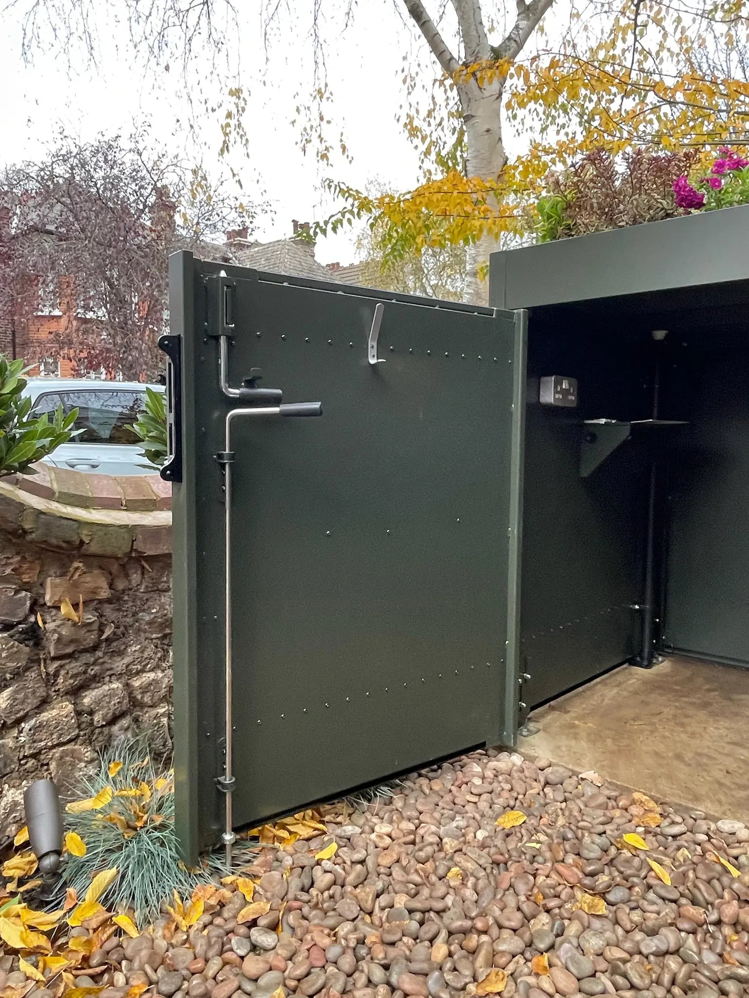 Detail of secure locking mechanism on bespoke front garden bike store designed for daily use