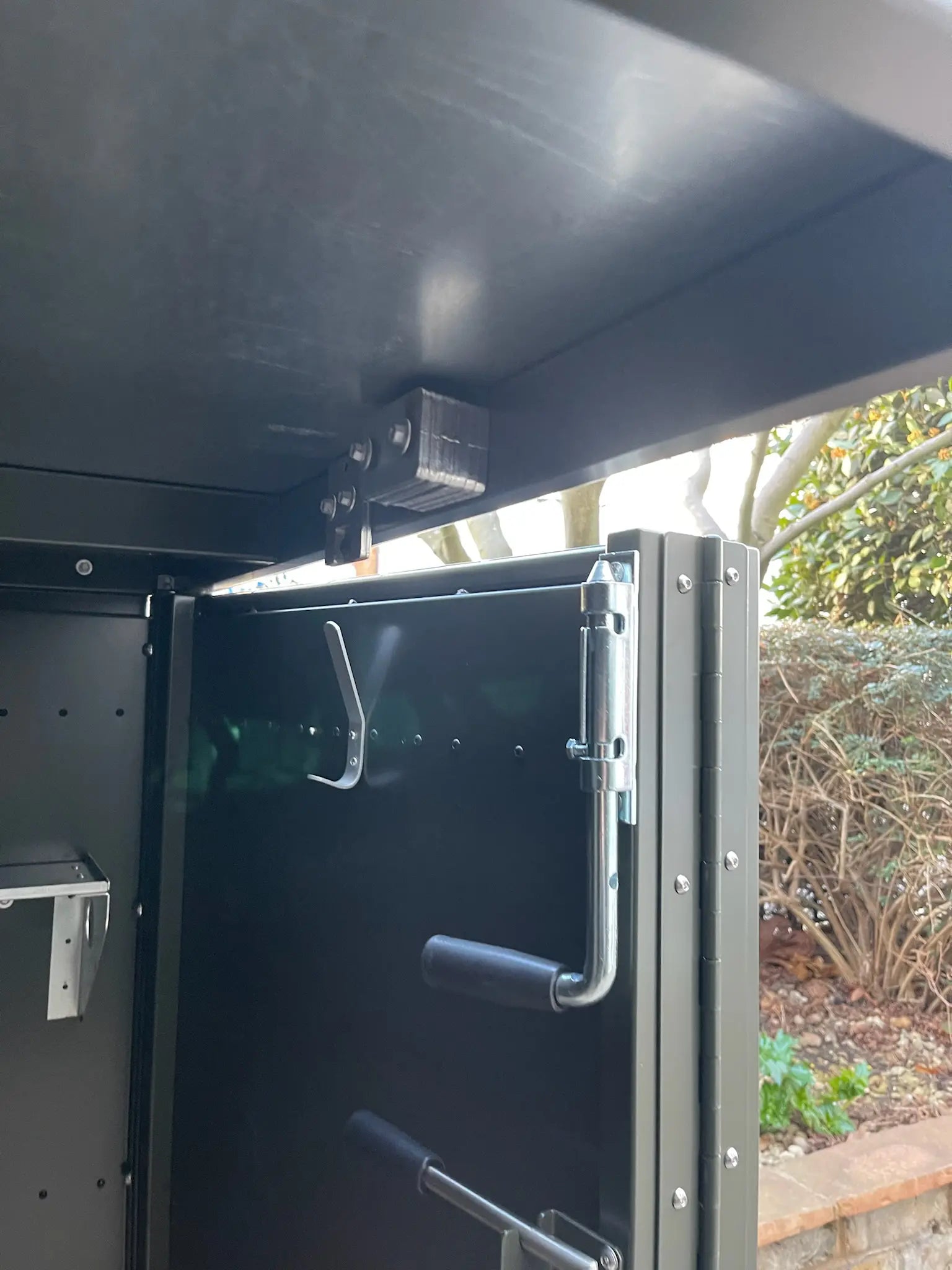 Detail of internal door locking mechanism inside bespoke bike store for smooth daily operation