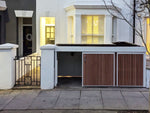 Elegant green roof bike shed enhancing property's value and contributing to neighborhood biodiversity.