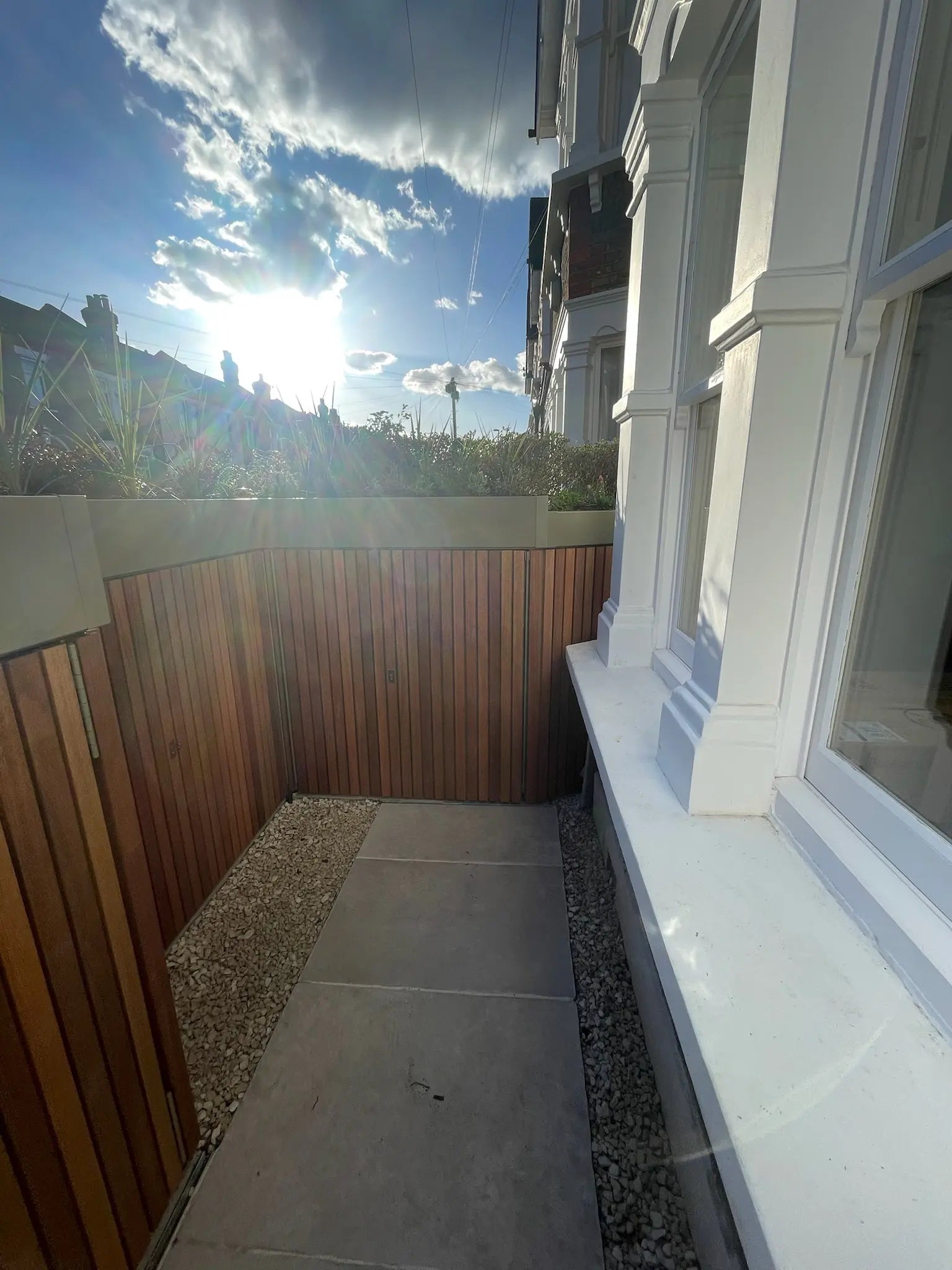 Detail of planted green roof above integrated front garden storage wall