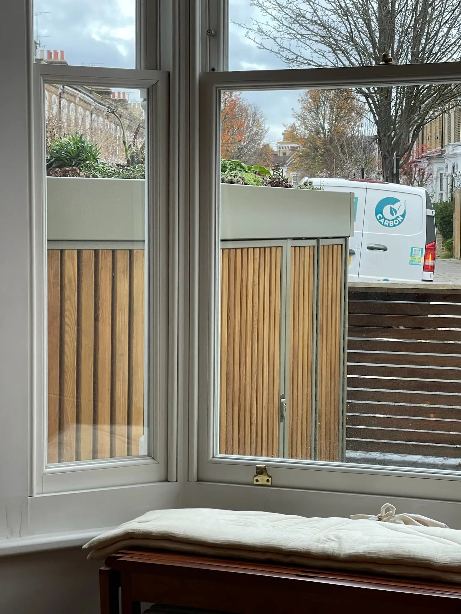 View of side-return bike store from bay window showing compact London front-garden storage