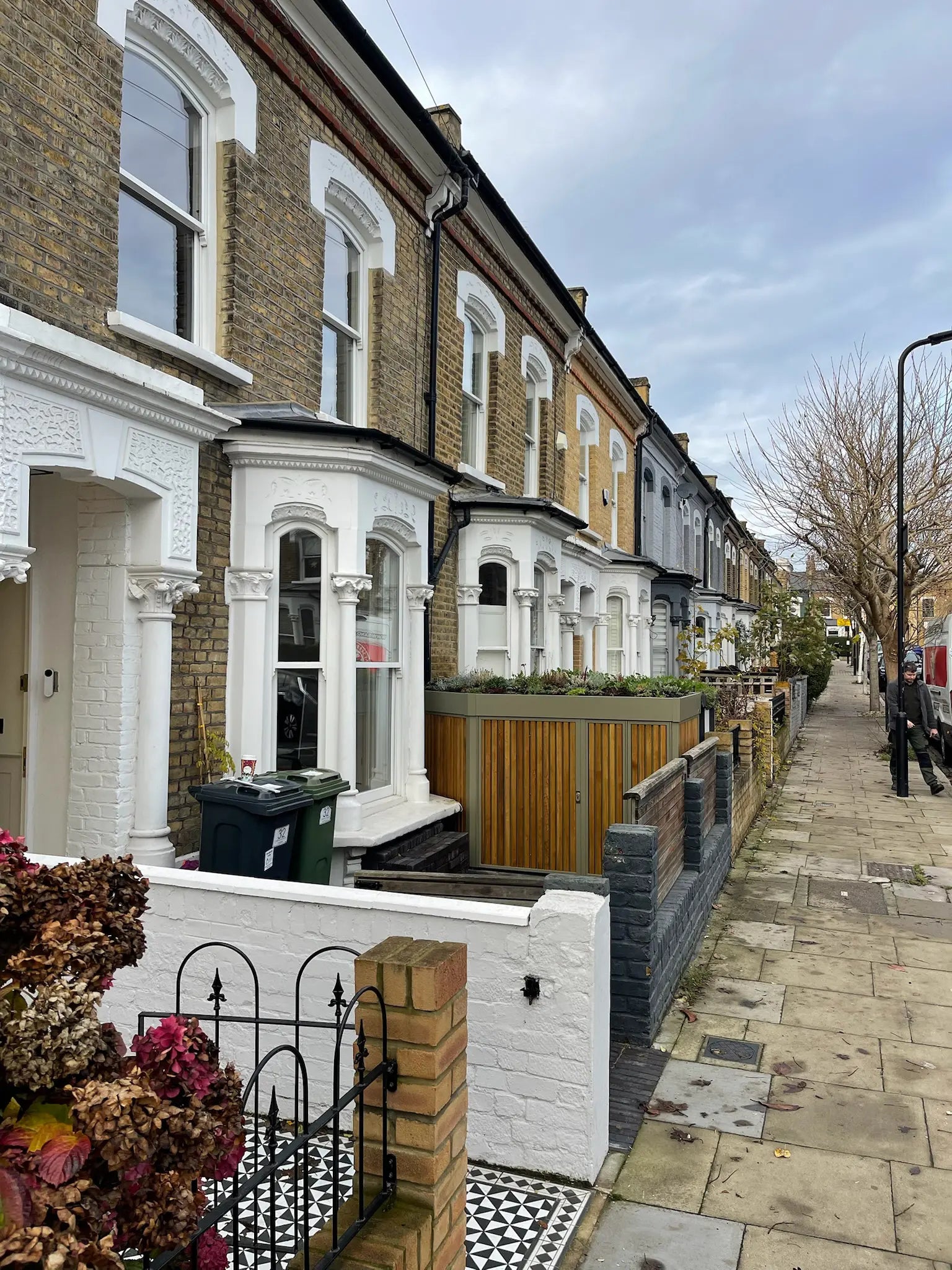 Discreet front-garden storage viewed from pavement, showing subtle street presence in London home