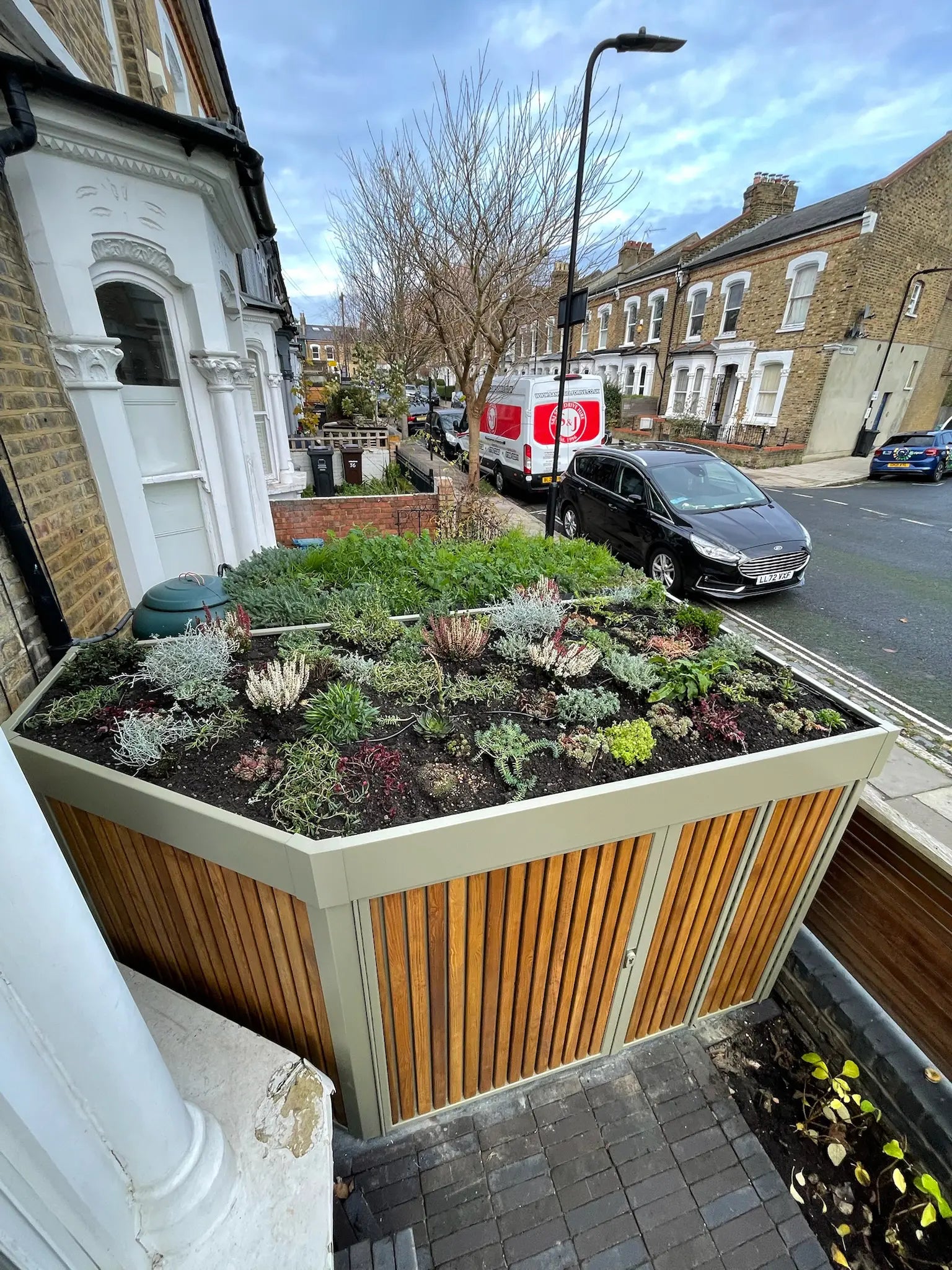 Aerial view of sedum green roof with mixed textures on side-return storage in London