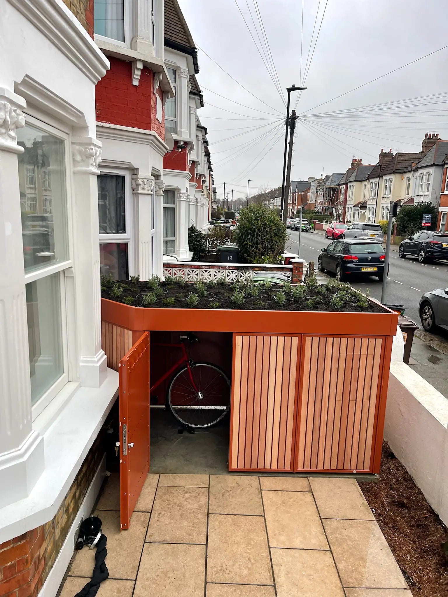 Open side access bike storage designed for easy daily use by a cycling family in London.