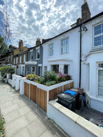  Full view from the street of a bespoke bin and bike store with a prominent planted green roof.